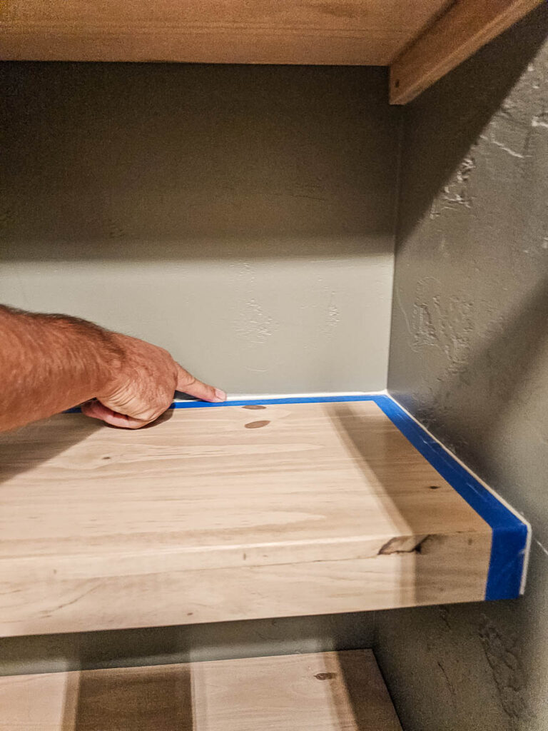 Then, he smooths the caulking with his finger after application.
