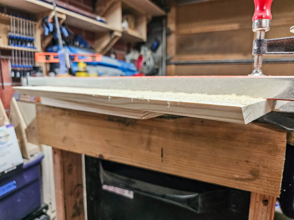 A photo of a wooden front board used to create floating bookshelves.