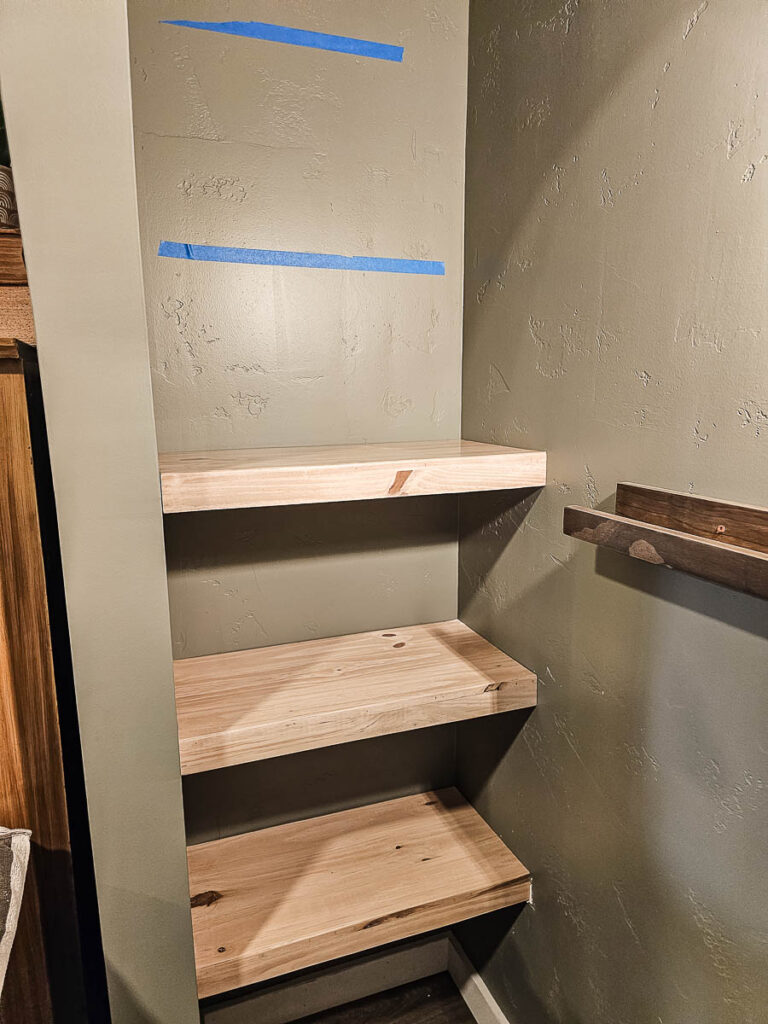 In the next photo, some floating bookshelves are already installed on the wall.