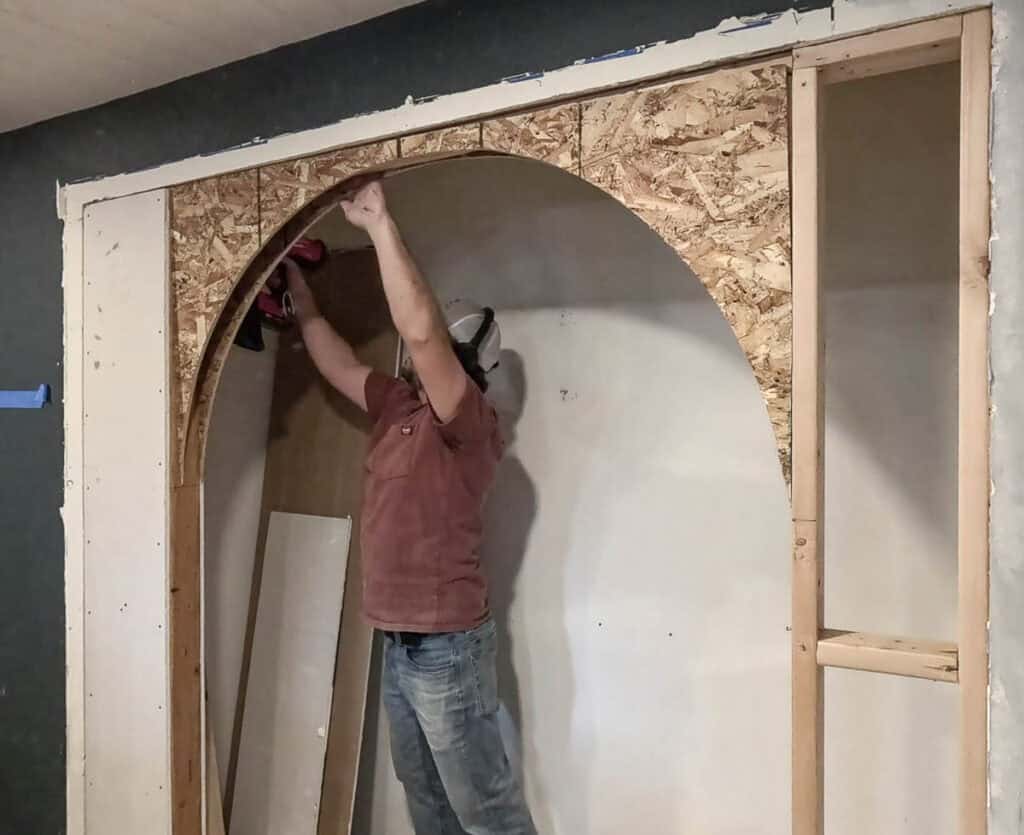 Attaching OSB sheets to both sides of an arch opening to a nook with a framing nailer