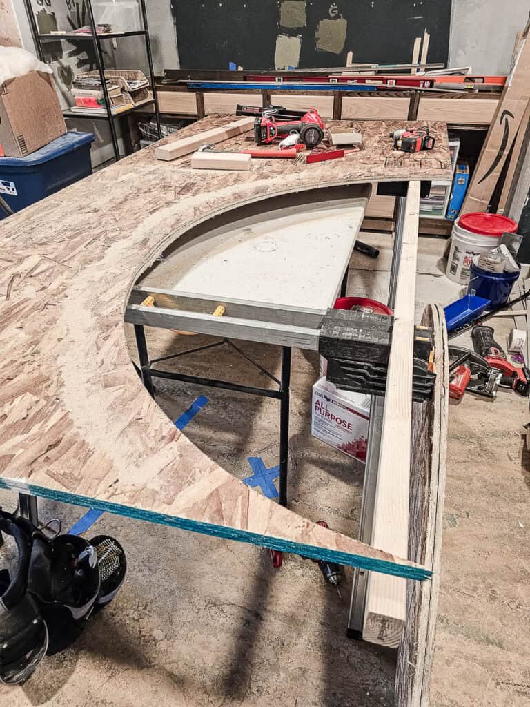 Sheet of OSB with arch shape cut out of it