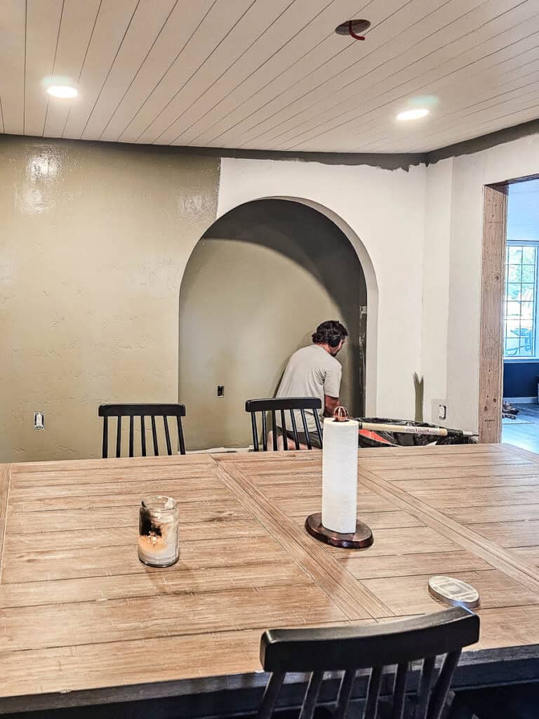 Painting walls and arched opening for reading nook with sage green color 