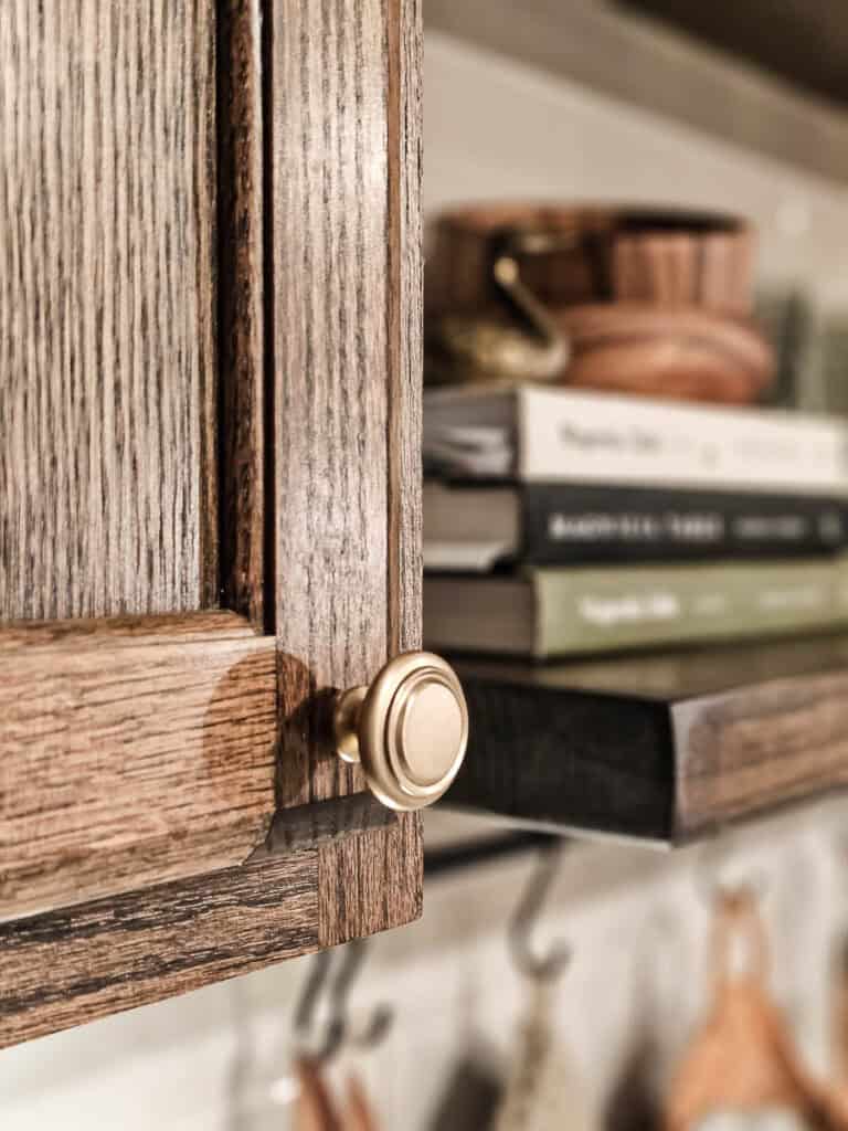 A close-up photo of a cabinet knob, as part of a reveal of a traditional-style dining room.