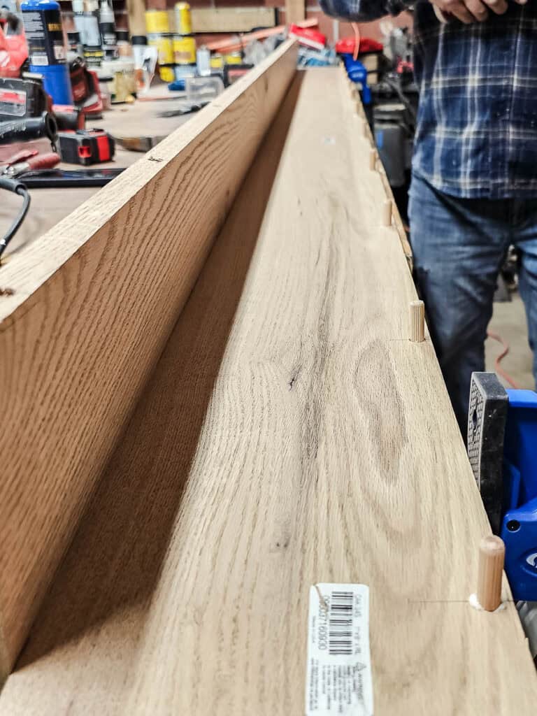 Detail showing dowel joinery before attaching both pieces of wood together