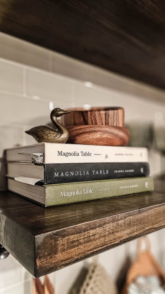 A close-up photo of books as part of a reveal photo of a traditional-style dining room.
