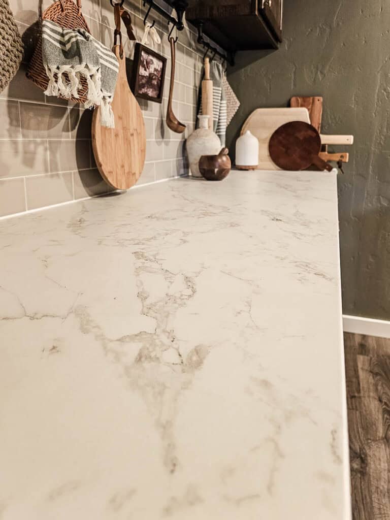 A reveal photo of a traditional-style dining room with a towel bar under the cabinet.