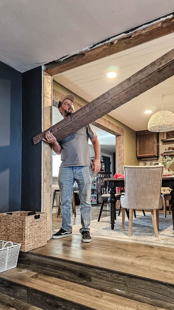 Adding fake wood beams in open concept with dining room 