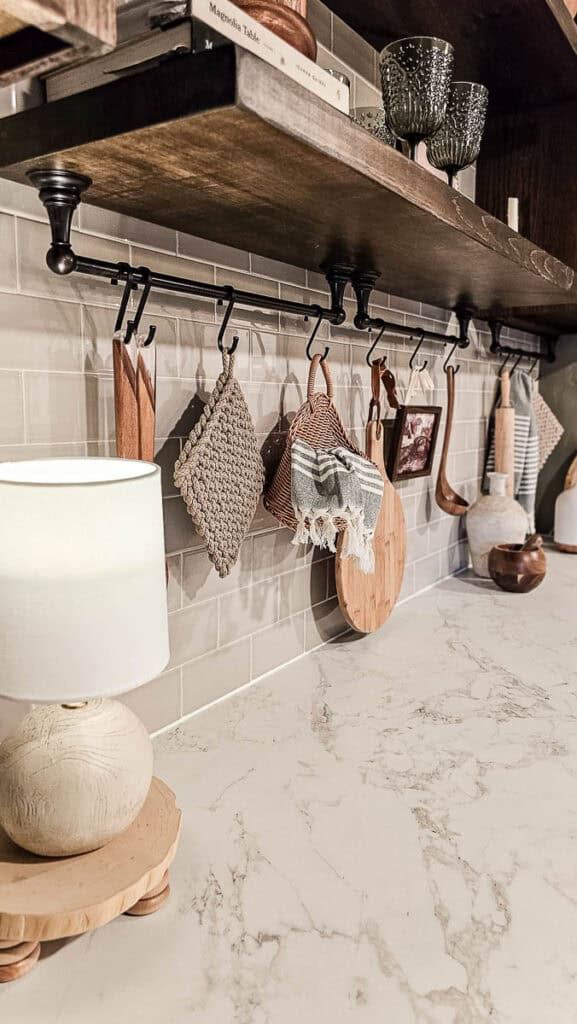 A photo of a hook and towel bar under the cabinet, added as part of a transitional dining room makeover.