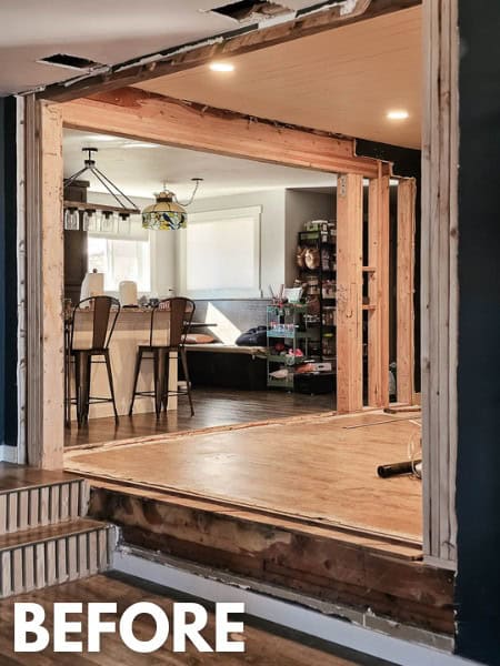 Openings between living room, dining room and kitchen before the renovation was finished with faux wood beams with text overlay that says before