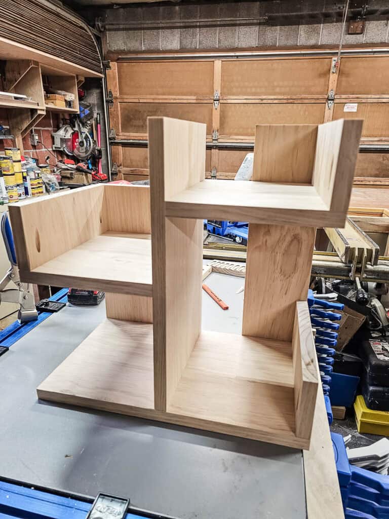 A photo of a fully assembled small bookshelf, showcasing the completed project made from a single piece of wood.
