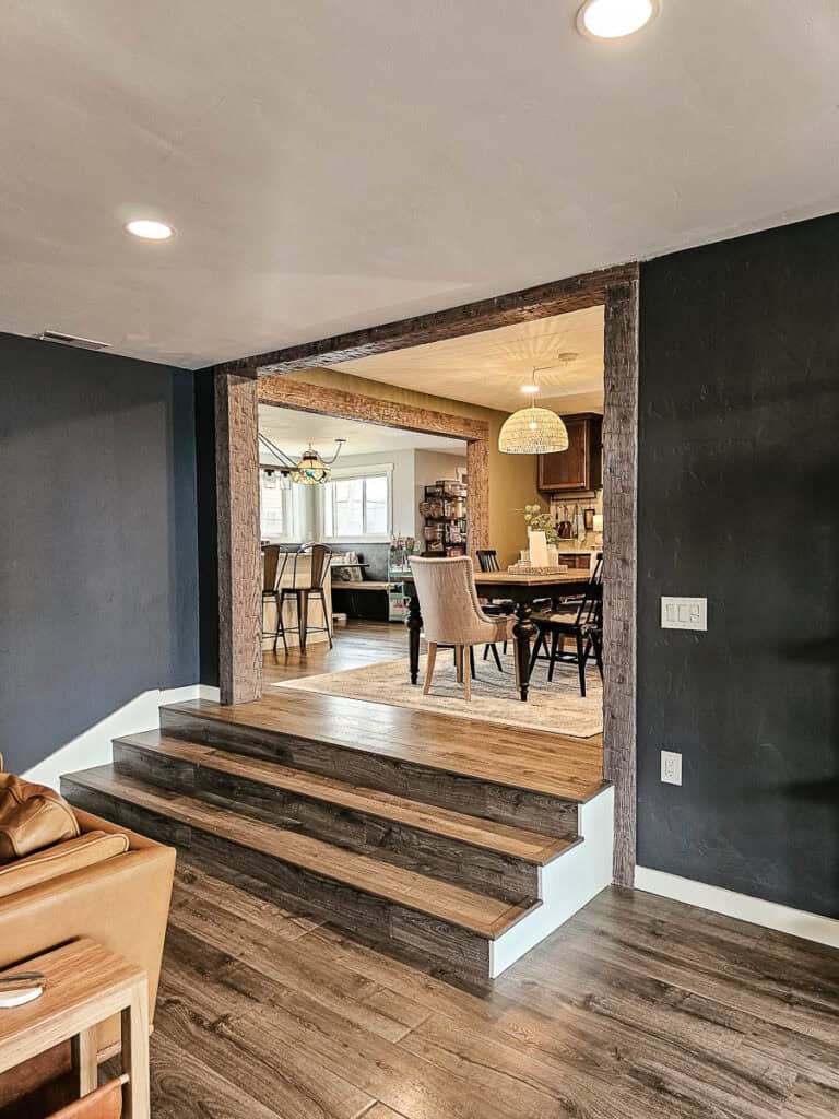 A reveal photo of a traditional-style dining room with stairs.