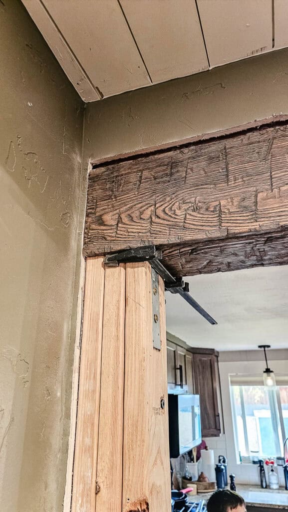 Wood header beam installed in opening and clamped into place during installation