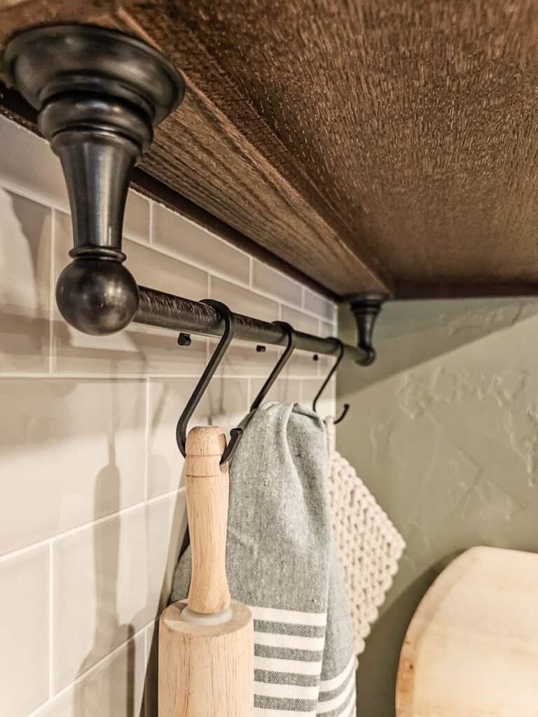 A photo of a hook under the cabinet, added as part of a transitional dining room makeover.
