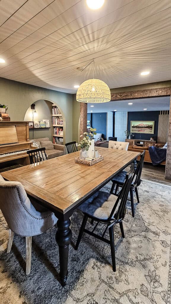 Dining room with large rattan basket light hanging from the ceiling over the dining room table