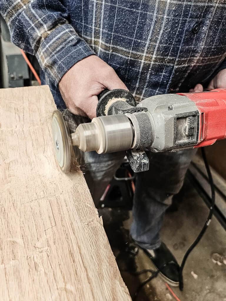Distressing wood for fake wood beams with wire wheel attached to a drill 