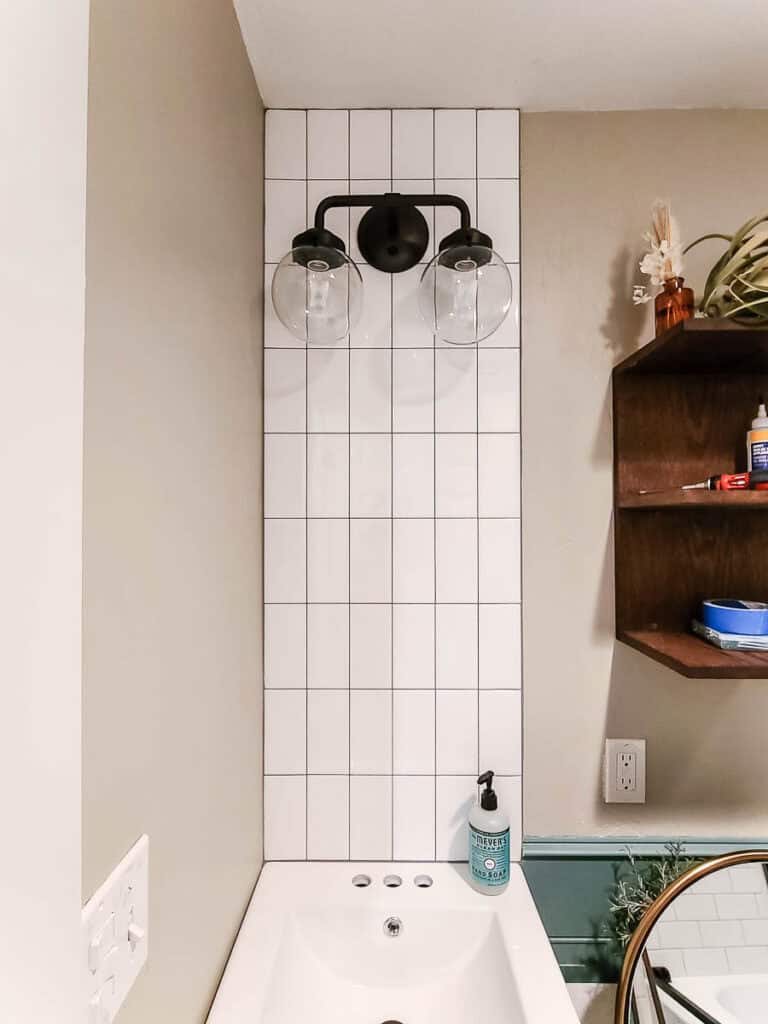 A reveal photo showing the application of Adhesive Tile Mat on shower walls, creating a clean and modern look.