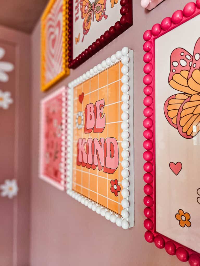 A close-up photo of six bobbin picture frames hanging on the wall.