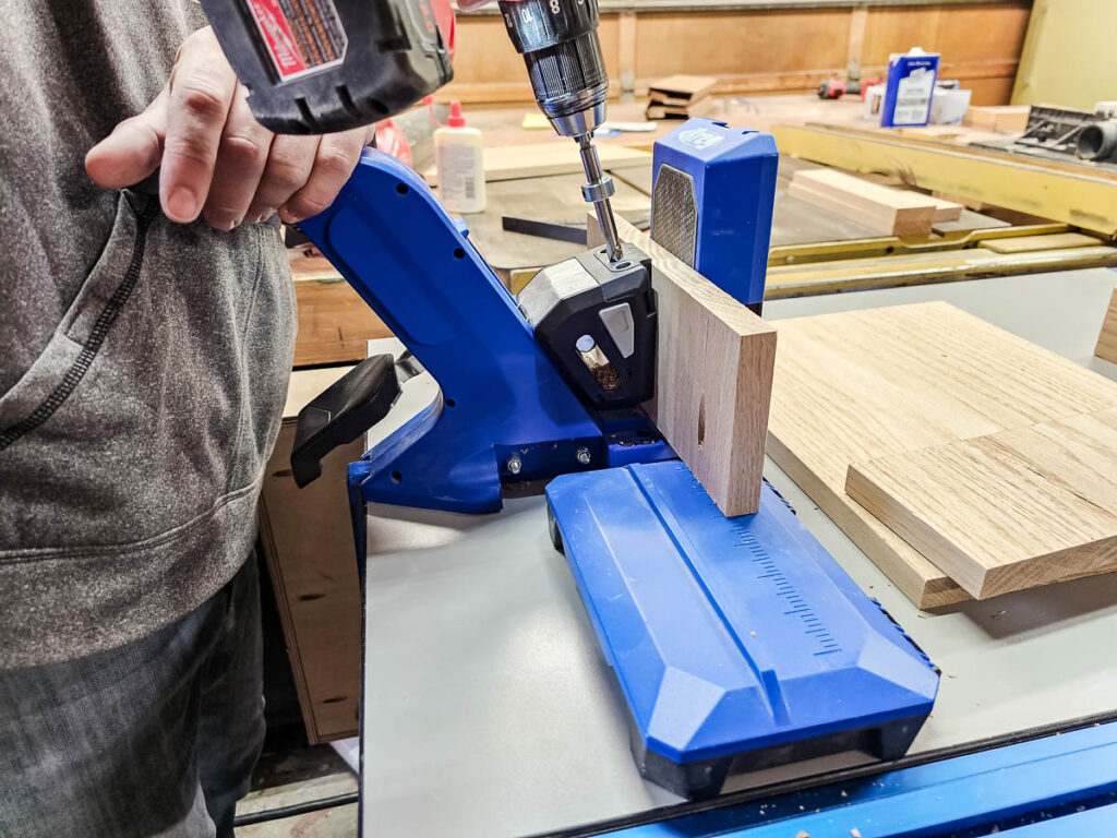 A photo of a man using the Kreg 720PRO Pocket Hole Jig to create precise pocket holes for woodworking projects.