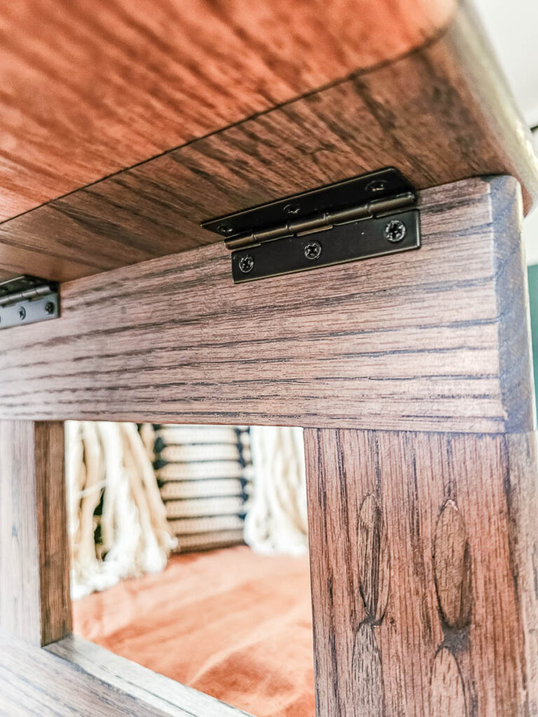 A photo showcasing the attached hinges on the wooden lap desk.