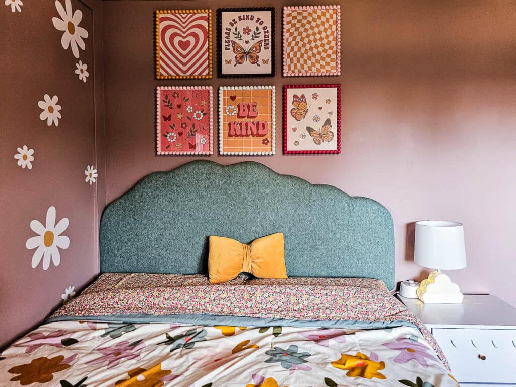 The finished DIY upholstered headboard with a scallop shape on the wall 