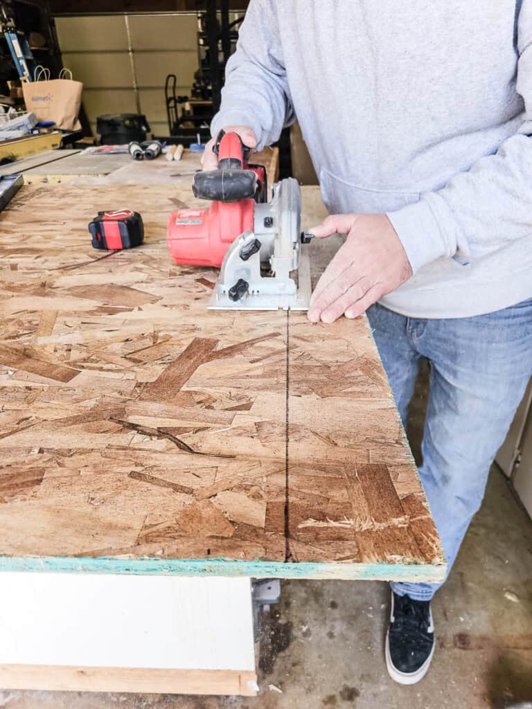 A photograph captures a man cutting OSB with a circular saw.
