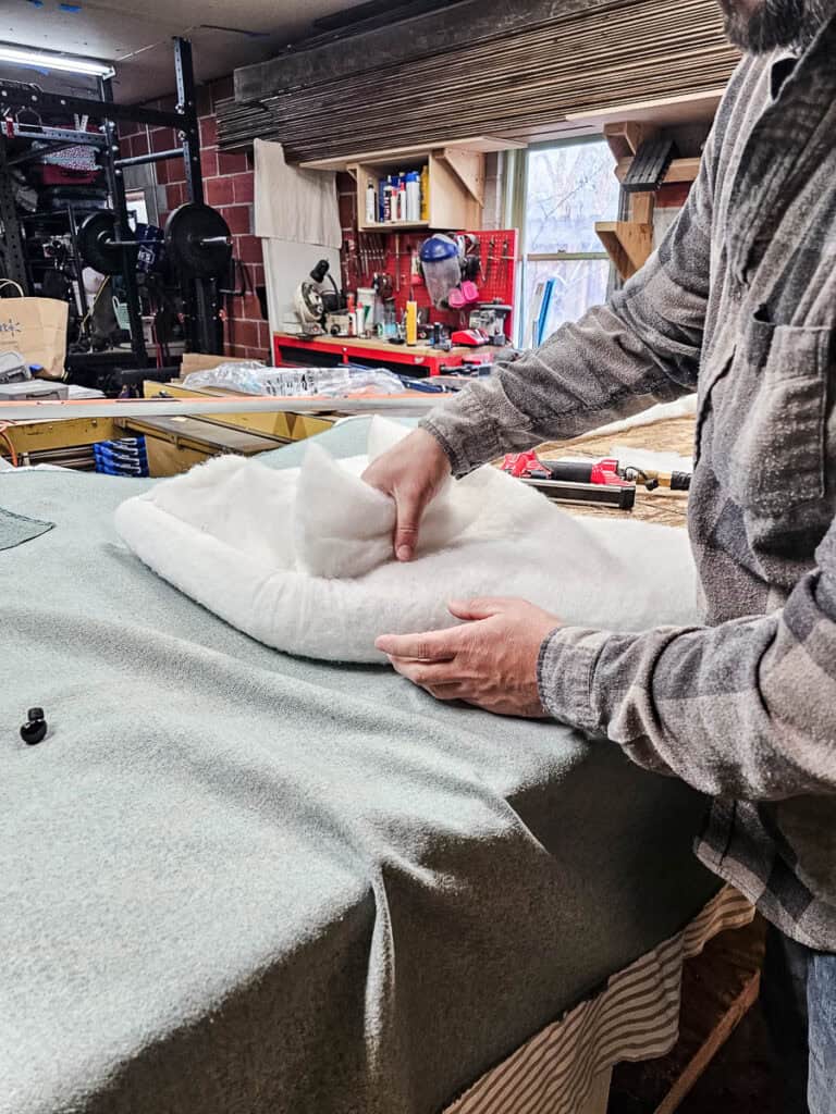 Attaching batting to the headboard before adding fabric for upholstered headboard 