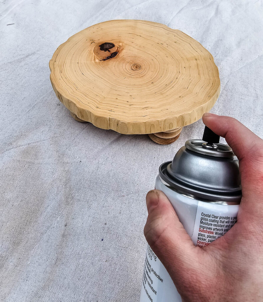 Another photo showing a person spraying the wooden riser.