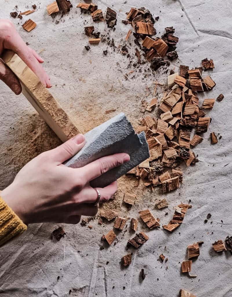 A photo of a person sanding the wood