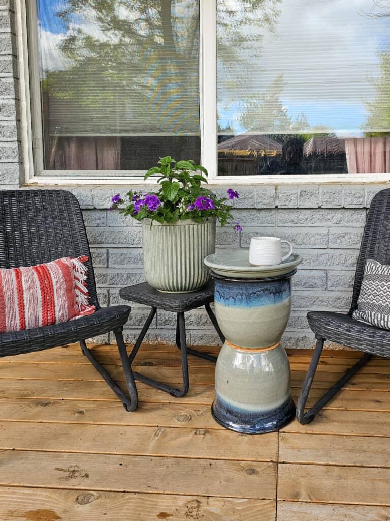 Close-up shot of a patio side table between two chairs, showcasing the texture and finish.