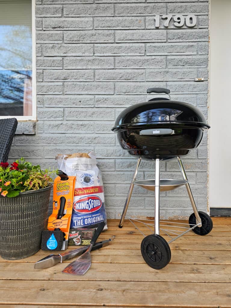 A picture of a black charcoal grill set up in the backyard.