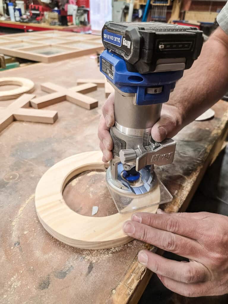 The man cut out the O’s with a jigsaw, sand smooth, and chamfer the edges with a router.